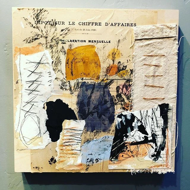 Mixed-media collage on a wooden panel: torn papers, an ocher and an indigo shape, graphite hatching and orange stitches on linen